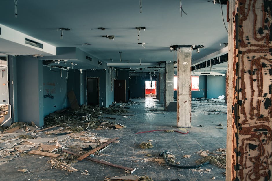 pexels-photo-5461946-5461946 Interior of an abandoned building showing decay and debris scattered across the floor.